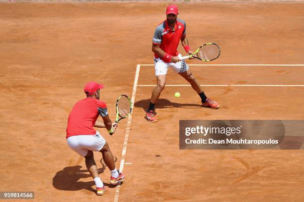 Juan Sebastian Cabal and Robert Farah both of Colombia compete in their quarter final doubles match against Lukasz Kubot of Poland and Marcelo Melo...