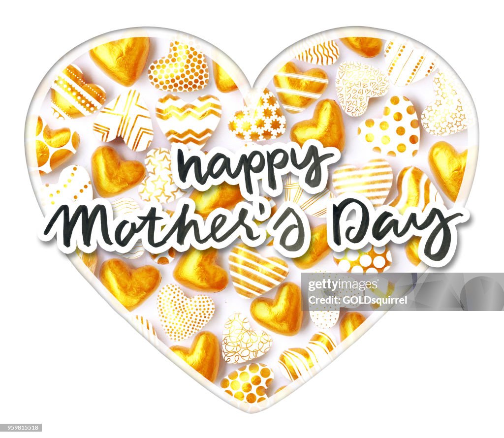 Happy Mother's Day text written in ink cut out of paper with a frame around and placed above the big heart filled with small 3D gold heart shapes - paper art composition