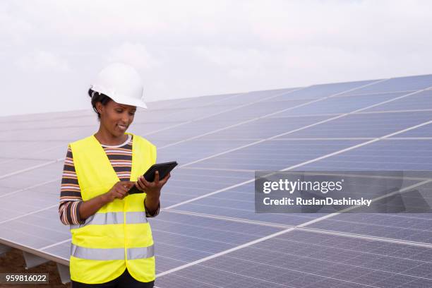 solar technician working with a tablet computer, checking data. - roof inspector stock pictures, royalty-free photos & images