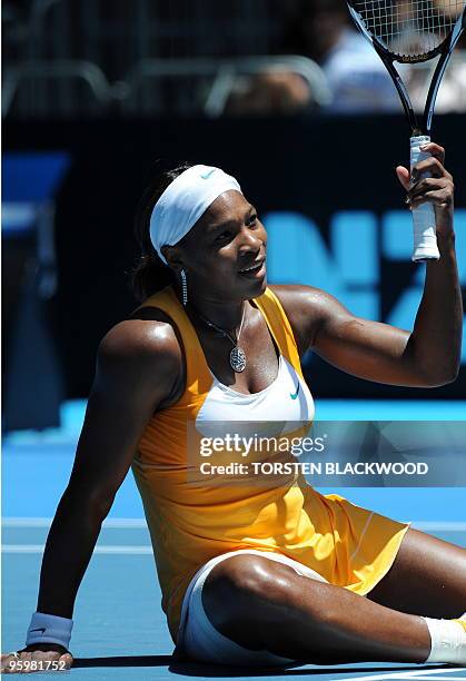 Tennis player Serena Williams gestures as she recovers from a fall during her third round women's singles match against Spanish opponent Carla Suarez...