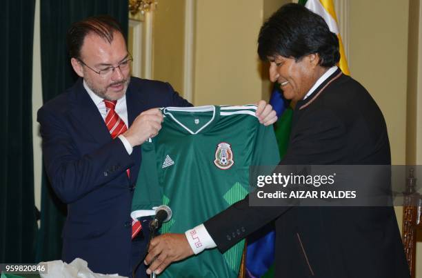 Mexico's Foreign Minister Luis Videgaray gives a jersey of the Mexican national football team to Bolivian President Evo Morales as a gift during a...