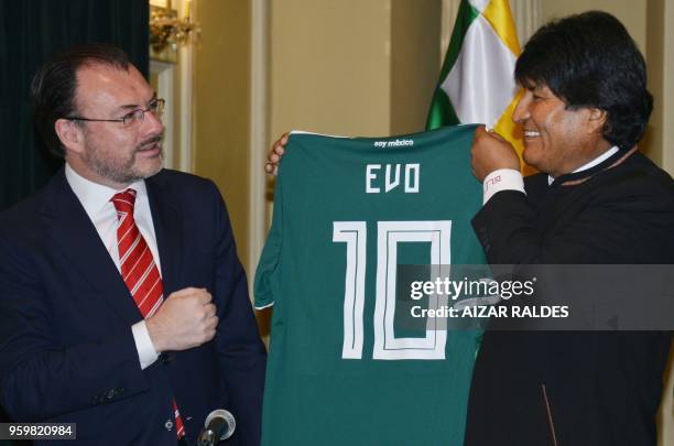 Mexico's Foreign Minister Luis Videgaray gives a jersey of the Mexican national football team to Bolivian President Evo Morales as a gift during a...