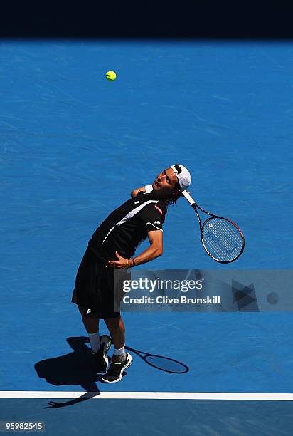 Albert Montanes of Spain serves in his third round match against Roger Federer of Switzerland during day six of the 2010 Australian Open at Melbourne...