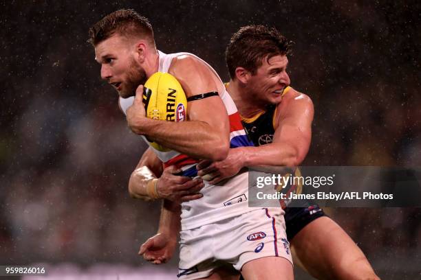 Jackson Trengove of the Bulldogs is tackled by Josh Jenkins of the Crows during the 2018 AFL round nine match between the Adelaide Crows and the...