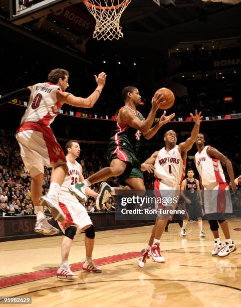 Charlie Bell of the Milwaukee Bucks looks to pass out of the double team of Marco Belinelli and Jarrett Jack of the Toronto Raptors during a game on...