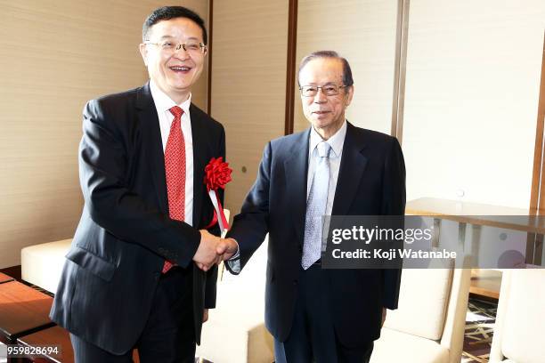 Former Japanese Prime Minister Yasuo Fukuda and Chinese Super League Chairman Li Yuyi shake hands during the Japan China Youth Football Cooperation...