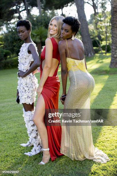 Fatou Jobe, Toni Garrn and Maria Borges pose for portrait during the cocktail at the amfAR Gala Cannes 2018 at Hotel du Cap-Eden-Roc on May 17, 2018...