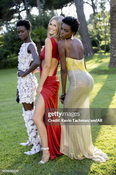 Fatou Jobe, Toni Garrn and Maria Borges pose for portrait during the cocktail at the amfAR Gala Cannes 2018 at Hotel du Cap-Eden-Roc on May 17, 2018...