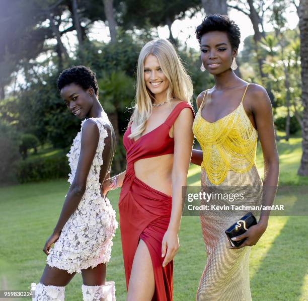 Fatou Jobe, Toni Garrn and Maria Borges pose for portrait during the cocktail at the amfAR Gala Cannes 2018 at Hotel du Cap-Eden-Roc on May 17, 2018...