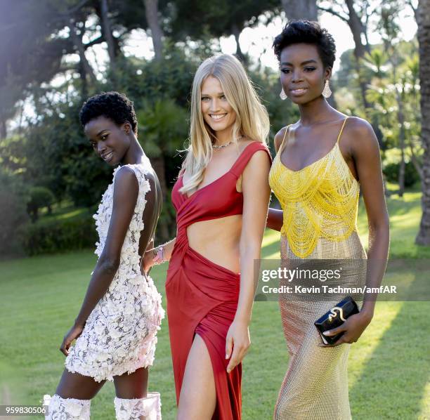 Fatou Jobe, Toni Garrn and Maria Borges pose for portrait during the cocktail at the amfAR Gala Cannes 2018 at Hotel du Cap-Eden-Roc on May 17, 2018...