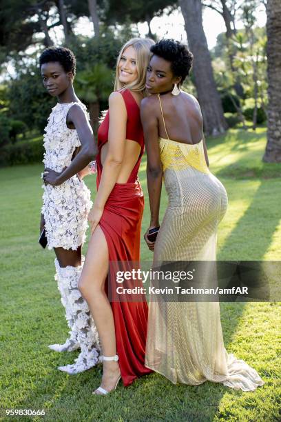 Fatou Jobe, Toni Garrn and Maria Borges pose for portrait during the cocktail at the amfAR Gala Cannes 2018 at Hotel du Cap-Eden-Roc on May 17, 2018...