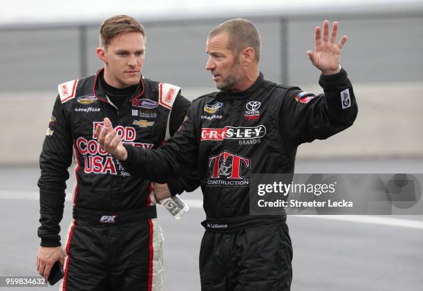 Bo LeMastus, driver of the Crosley Brands Toyota, and Parker Kligerman, driver of the Food Country USA Chevrolet, talk during practice for the NASCAR...