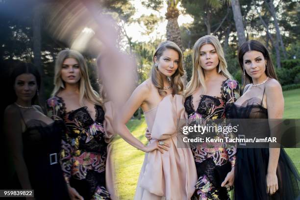 Eniko Mihalik, Maryna Linchuk and Julia Restoin Roitfeld attend the cocktail at the amfAR Gala Cannes 2018 at Hotel du Cap-Eden-Roc on May 17, 2018...