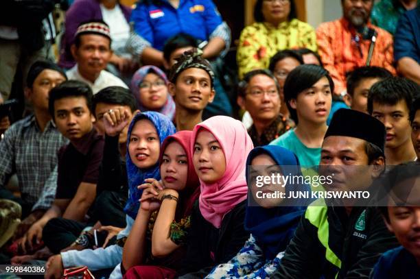 Indonesians from different religious groups take part in a joint prayer for the victims of a bomb attack on a church in Surabaya on May 18, 2018. -...