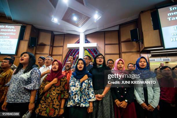 Indonesians from different religious groups take part in a joint prayer for the victims of a bomb attack on a church in Surabaya on May 18, 2018. -...