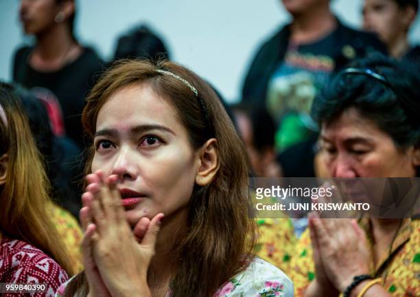 Indonesians from different religious groups take part in a joint prayer for the victims of a bomb attack on a church in Surabaya on May 18, 2018. -...