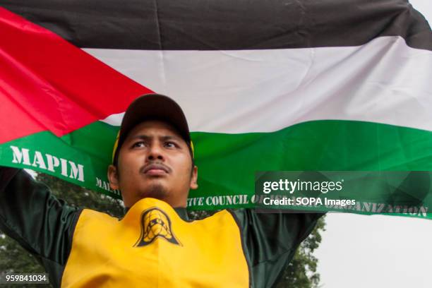 Men seen holding the Palestinian flag to show his support against the Israel cruelty. Even it is the holy Ramadhan, hundreds of Muslim in Malaysia...