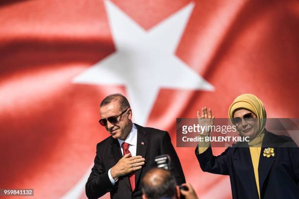 Turkish President Recep Tayyip Erdogan and his wife Emine Erdogan wave as they greet the crowd during a protest rally in Istanbul on May 18 against...