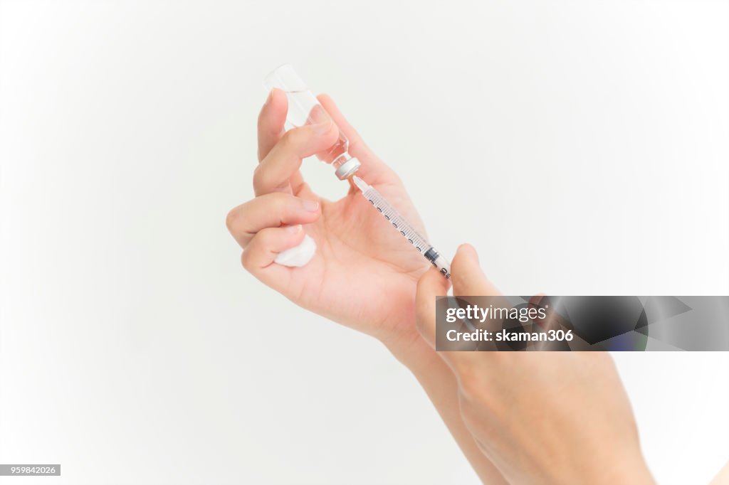 Selective focus and close up shot needle of syringe for insulin patient with white background
