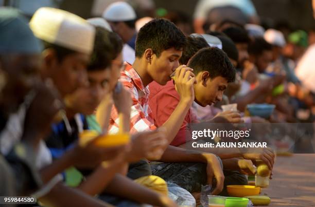Indian Muslims break their Ramadan fast during the first day of the month of Ramadan at Wallajah Mosque in Chennai on May 18, 2018. - Like millions...