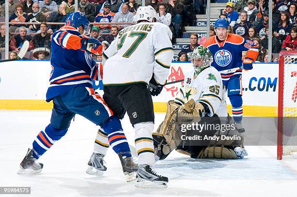 Marty Turco of the Dallas Stars makes a save while Andrew Cogliano of the Edmonton Oilers puts pressure on the net on January 22, 2010 at Rexall...