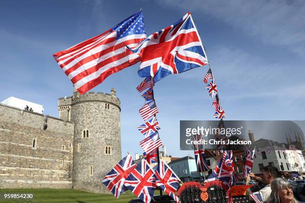 The national flags of Great Britain and the United States fly over a merchandise stall ahead of the royal wedding of Prince Harry and Meghan Markle...