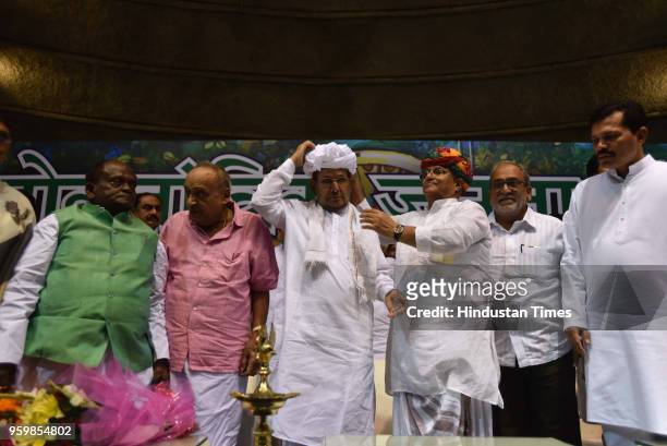 Politician Sharad Yadav is felicitated with traditional Rajasthani turban during the launch of new party Loktantrik Janata Dal at Talkatora Stadium,...