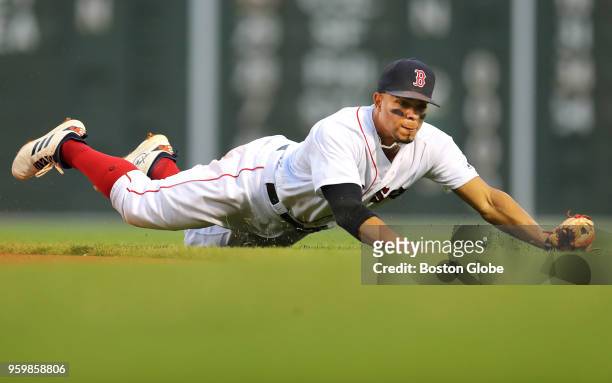 Boston Red Sox shortstop Xander Bogaerts dives to stop a ground ball hit in the second inning by Orioles' Chris Davis. The Boston Red Sox host the...