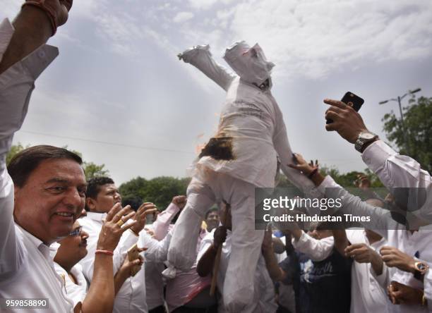 Congress supporters burn the effigy of PM Narendra Modi as DPCC President Ajay Maken with former Delhi CM Sheila Dikshit protests to "Save the...