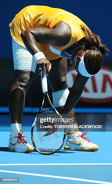 Tennis player Serena Williams reacts during her third round women's singles match against Spanish opponent Carla Suarez Navarro at the Australian...