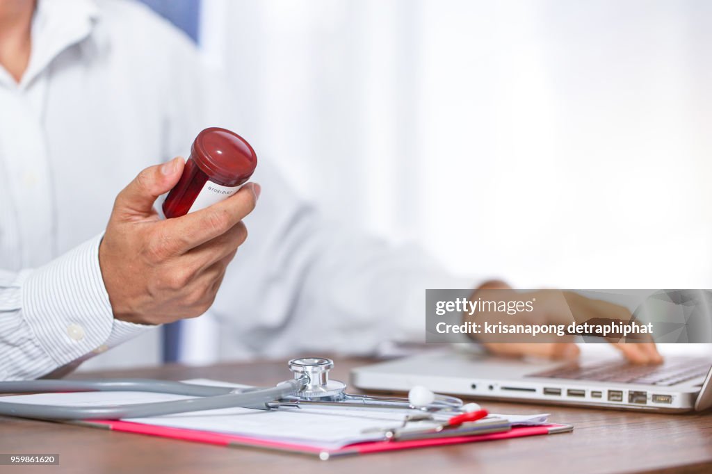 A young doctor prescribes medication. prescription pills are prescribed by the doctor.