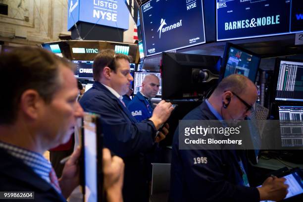 Traders work on the floor of the New York Stock Exchange in New York, U.S., on Friday, May 18, 2018. U.S. Stocks fluctuated, the dollar rose and...