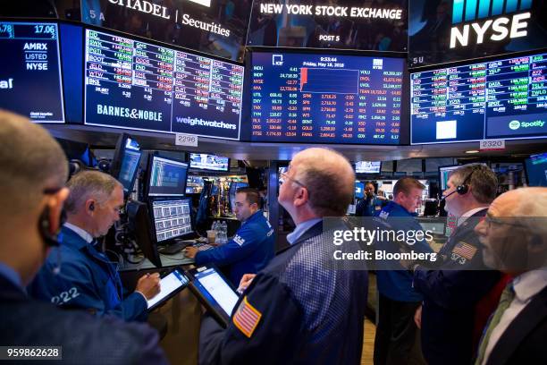 Traders work on the floor of the New York Stock Exchange in New York, U.S., on Friday, May 18, 2018. U.S. Stocks fluctuated, the dollar rose and...