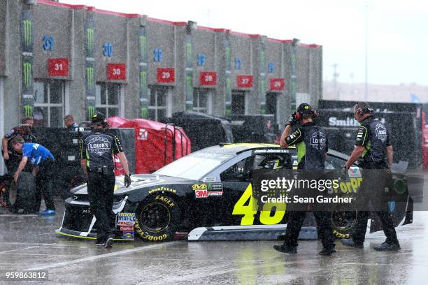 Jimmie Johnson, driver of the Lowe's for Pros Chevrolet drives through the garage during a rain delay during practice for the Monster Energy NASCAR...