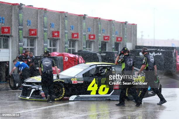 Jimmie Johnson, driver of the Lowe's for Pros Chevrolet drives through the garage during a rain delay during practice for the Monster Energy NASCAR...
