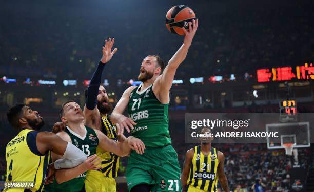 Fenerbahce's Jason Thompson and Luigi Datome vie for the ball with Zalgiris' Milaknis Arturas and Paulius Jankunas during the first semi-final...