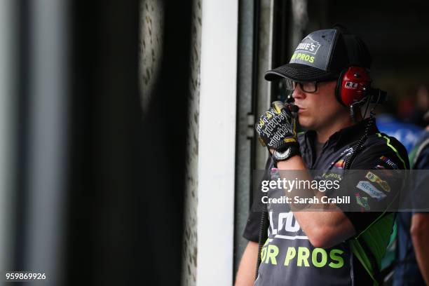 Crew member of the Lowe's for Pros Chevrolet stands in the garage during a rain delay during practice for the Monster Energy NASCAR Cup Series...