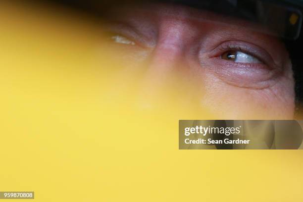 Kyle Busch, driver of the M&M's Red Nose Day Toyota, sits in his car during practice for the Monster Energy NASCAR Cup Series All-Star Race at...