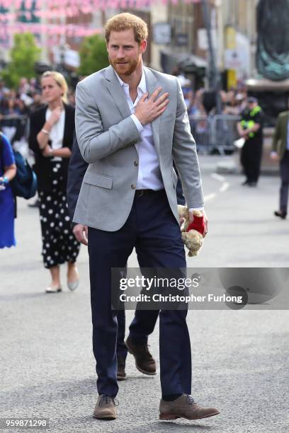 Prince Harry greets members of the public as he embarks on a walkabout ahead of the royal wedding of Prince Harry and Meghan Markle on May 18, 2018...