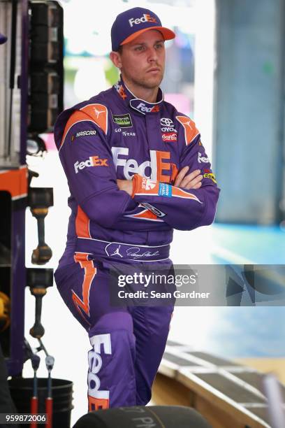 Denny Hamlin, driver of the FedEx Express Toyota, stands in the garage area during practice for the Monster Energy NASCAR Cup Series All-Star Race at...