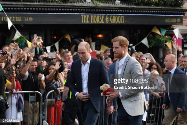 Prince Harry and Prince William, Duke of Cambridge embark on a walkabout ahead of the royal wedding of Prince Harry and Meghan Markle on May 18, 2018...
