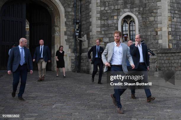 Prince Harry and Prince William, Duke of Cambridge embark on a walkabout ahead of the royal wedding of Prince Harry and Meghan Markle on May 18, 2018...