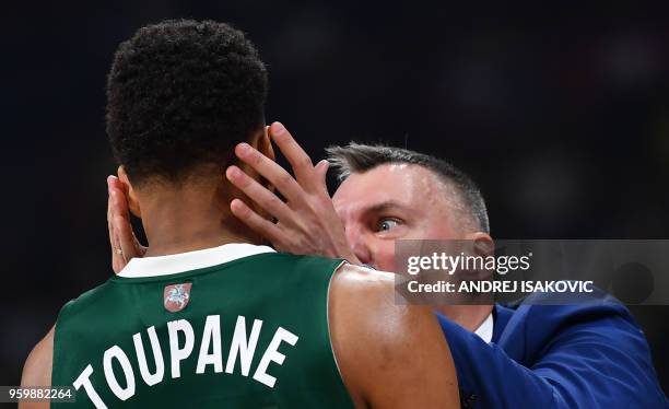 Zalgiris' Lithuanian head coach Sarunas Jasikevicius embraces Zalgiris' French forward Axel Toupane during the first semi-final EuroLeague Final Four...