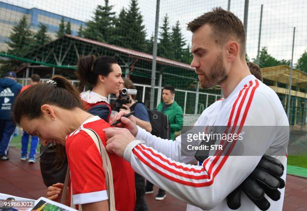 Russian national football team goalkeeper Igor Akinfeyev gives an autograph before a training session in Novogorsk outside Moscow on May 18, 2018.
