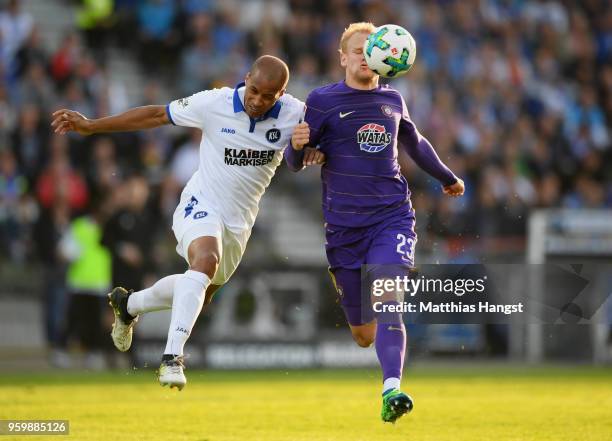 David Pisot of Karlsruhe and Soeren Bertram of Aue compete for the ball during the 2. Bundesliga Playoff Leg 1 match between Karlsruher SC and...