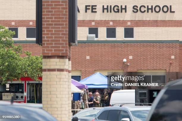 Emergency crews gather in the parking lot of Santa Fe High School where at least eight people were killed on May 18, 2018 in Santa Fe, Texas. At...