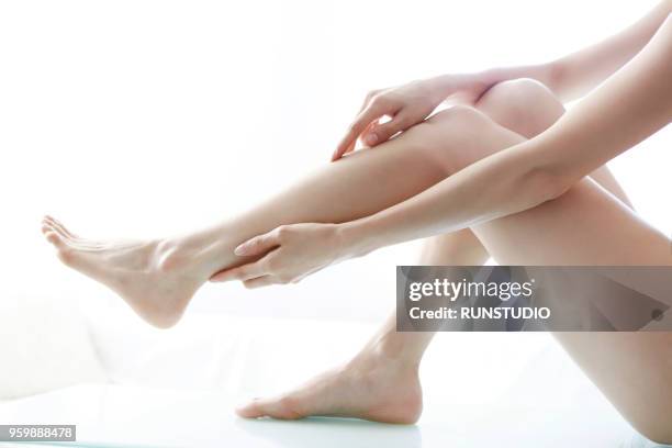 woman touching legs - 美脚 ストックフォトと画像