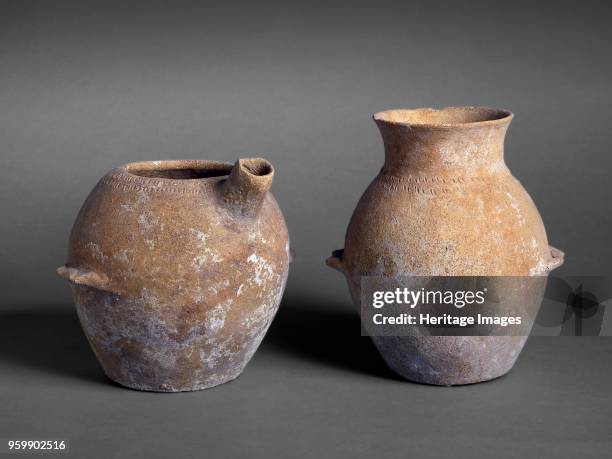 Jars, Inter. EB-MB, circa 1700-1500BC. Jars: one of pink buff ware, small white grits, hand made with wheel made neck, everted rim, rounded body,...