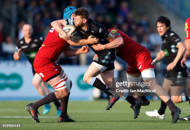 Finn Russell of Glasgow Warriors is tackled by James Davies of Scarlets during the Guinness Pro14 Semi Final match between Glasgow Warriors and...