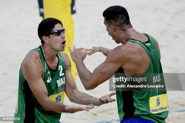 Alvaro Filho and Saymon Barbosa of Brazil in action during the main draw match against Kacper Kujawiak and Maciej Rudol of Poland at Meia Praia Beach...